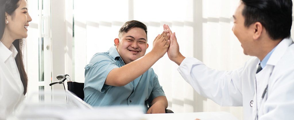 Person high-fives a healthcare provider during a clinic visit.